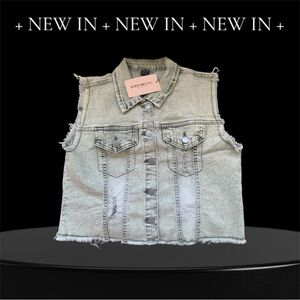 Woman’s distressed denim cut-off vest